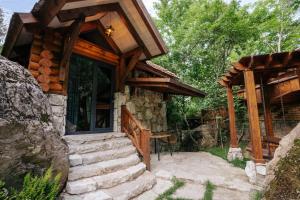 a log cabin with stairs leading to a porch at Getahovit Resort in Ijevan
