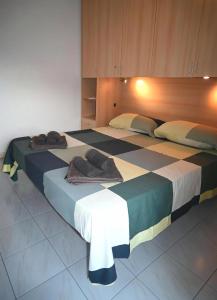 two beds in a hotel room with towels on them at Maremonti in Letojanni