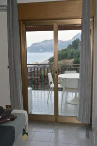 a room with a balcony with a view of the ocean at Maremonti in Letojanni