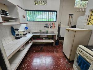 a small kitchen with a sink and a refrigerator at VILLA ELSA in El Colegio
