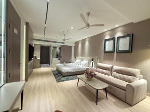 a living room with a couch and a bed at Vijan Mahal in Jabalpur