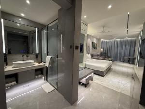 a bathroom with a sink and a bed in a room at Vijan Mahal in Jabalpur