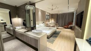 a bathroom with a bed and a large mirror at Vijan Mahal in Jabalpur