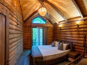 a bedroom in a log cabin with a bed in it at Getahovit Resort in Ijevan +205 photos