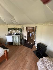 a room with a tent with a table in it at Old Dairy Farm Glamping in Emsworth