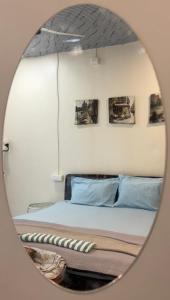 a mirror reflection of a bed in a bedroom at Countryside Retreat in Pune +46 photos