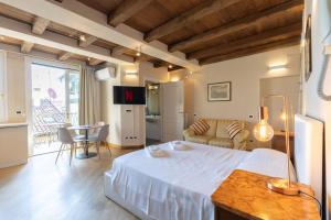 a bedroom with a bed and a living room at BolognaRoomscom - Santo Stefano Apartments in Bologna