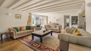 a living room with couches and a coffee table at Butts Farm in Cirencester