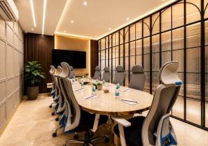 a conference room with a long table and chairs at Hotel The Venue At Delhi Airport IGI in New Delhi