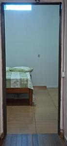 a bedroom with a bed in the middle of a room at Home Comfort in Poconé +4 photos