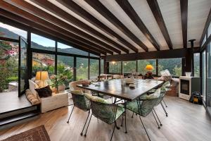 a large living room with a table and chairs at Villa Daphne Pool And Jacuzzi in Vescina