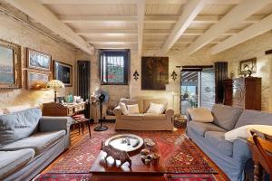 a living room with two couches and a table at Villa Daphne Pool And Jacuzzi in Vescina