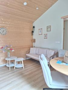 a living room with a couch and a table at Rekerlanden 260 in Schoorldam +14 photos