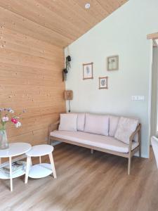 a living room with a couch and a table at Rekerlanden 260 in Schoorldam