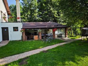a house with a patio with a table and chairs at Casa Irina in Horezu