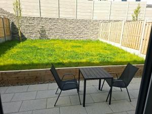a table and two chairs and a table and a lawn at Spacious ensuite bedroom in Kiltiernan