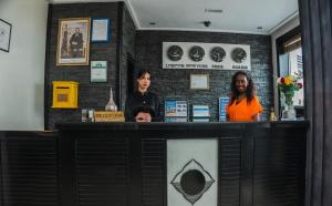 two women standing at a counter in a restaurant at Studiotel Afoud in Agadir