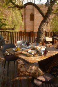 a wooden table with food on top of a tree at Room 7 in Nizwa +8 photos