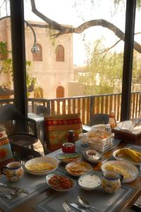 a table with plates and bowls of food on it at Room 7 in Nizwa