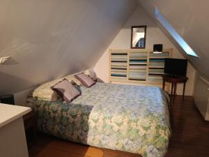 a bedroom with a bed in a attic at Chez Annick in Valfleury