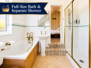 a bathroom with a tub and a sink and a shower at Holly Trees Guest Accommodation in Seahouses +38 photos