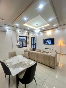 a living room with a couch and a table at Western Suites in Douala