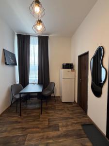 a room with a table and chairs and a refrigerator at Apartmán Pardubice 4 in Pardubice