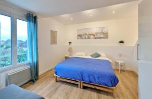 a bedroom with a bed and a large window at L'Hirondelle - Charming flat - in Blotzheim +22 photos