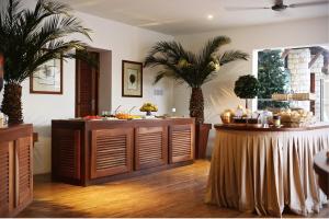 a room with a buffet with palm trees in it at Hotel Morabeza in Santa Maria