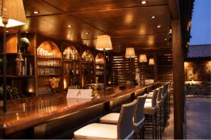 a bar in a restaurant with chairs and a counter at Hotel Morabeza in Santa Maria +88 photos
