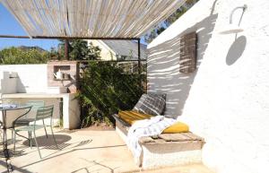 a patio with a couch and a table on a patio at De Waenhuis Cottage in Calitzdorp