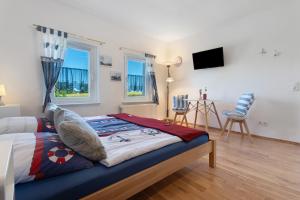 a bedroom with a bed and a tv in it at Villa Wiese Störtebecker in Katzow
