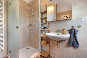 a bathroom with a sink and a shower at Villa Wiese Störtebecker in Katzow +22 photos
