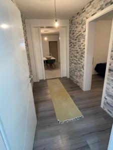 a hallway with a room with a brick wall at Apartmen Emina 1 in Doglodi