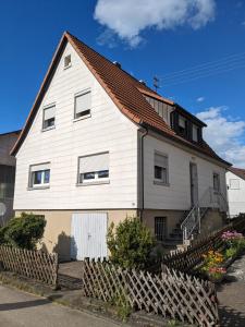 a white house with a red roof at Härtsfeldwohnungen in Neresheim