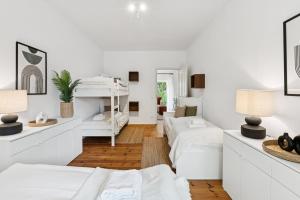 a white room with two beds and two lamps at Arbio Monteurzimmer Behnitzer Parking included in Nauen