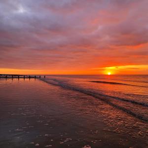 a sunset over the ocean with a pier at The Beachcroft Hotel, BW Signature Collection in Bognor Regis