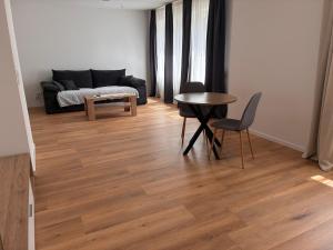 a living room with a couch and a table and chairs at Haus Sissi in Daun