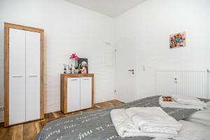 a bedroom with two beds and a mirror at Danma Ferienwohnung Apartment Eifel in Laubach