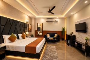 a hotel room with a bed and a flat screen tv at Hotel Jiio in Kurukshetra