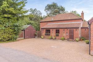 an old brick house with a garage and a driveway at 3 Bed in Acle oc-b41410 in Acle +15 photos