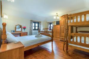 a bedroom with two bunk beds and a mirror at 3 Bed in Acle oc-b41410 in Acle