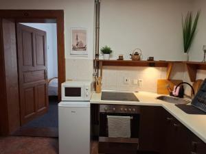 a kitchen with a sink and a stove top oven at Penzion U školy in Staré Město +32 photos
