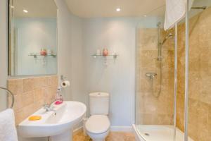 a bathroom with a toilet and a sink and a shower at 3 Bed in Briningham oc-s44878 in Banningham +15 photos