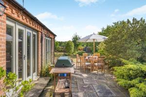a patio with a grill and a table and chairs at 3 Bed in Briningham oc-s44878 in Banningham