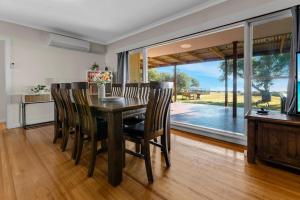 a dining room with a wooden table and chairs at Tranquility Point in Raymond Island