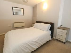 a bedroom with a large white bed and a nightstand at Chandlers Nook in Portland