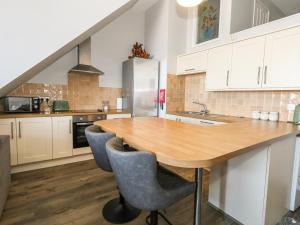 a kitchen with a wooden table and chairs at Chandlers Nook in Portland