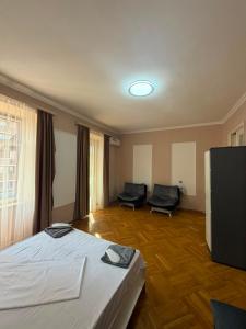 a hotel room with two beds and two chairs at best hotel yerevan in Yerevan