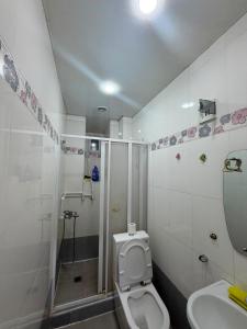 a bathroom with a toilet and a shower and a sink at best hotel yerevan in Yerevan